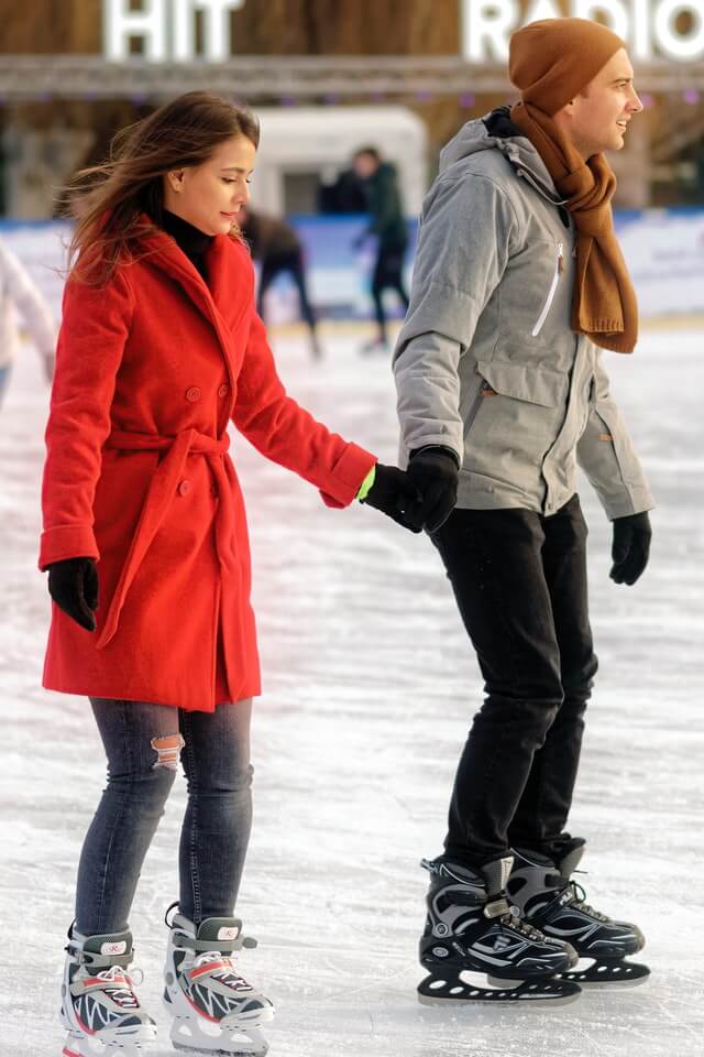 couple ice skating in rink