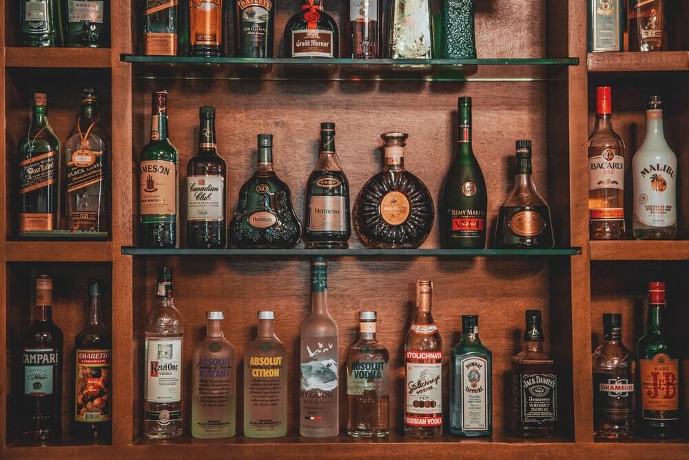 A wooden shelf full of bottles