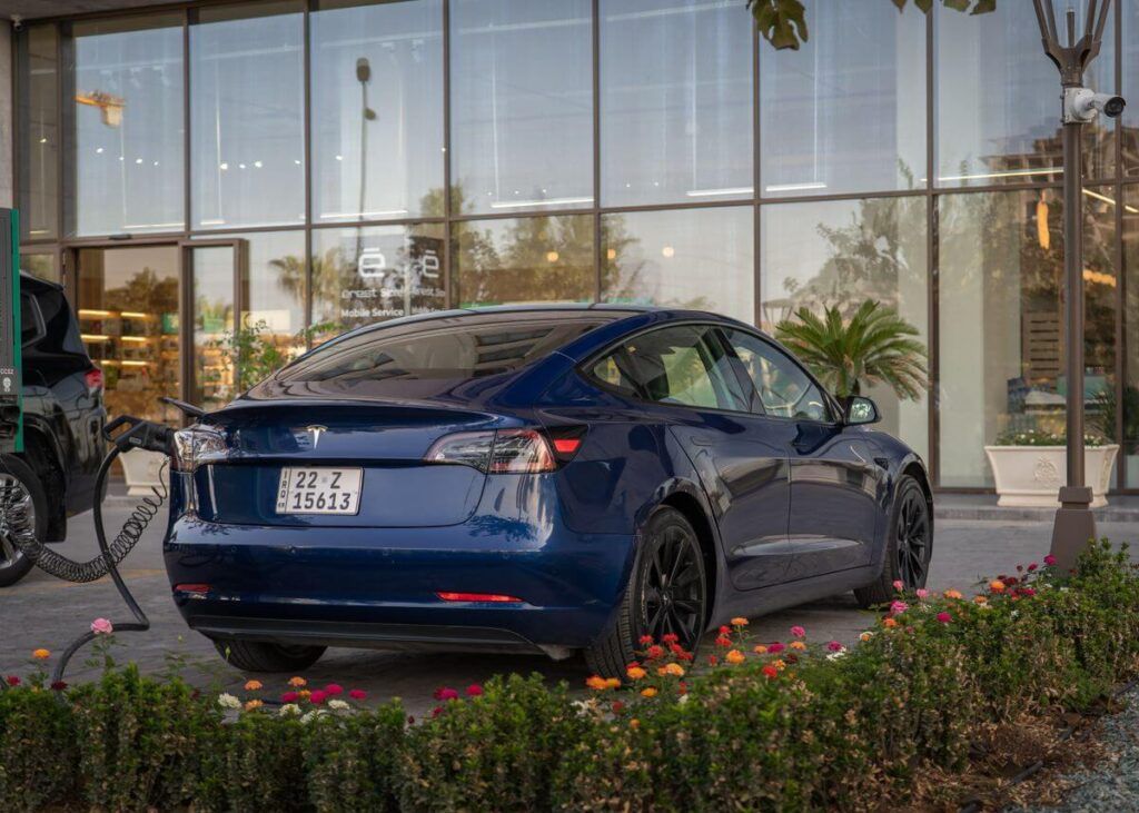 Tesla Model 3 charging at a modern EV charging station